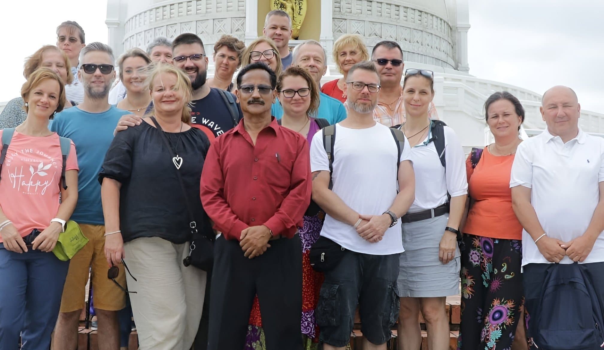 Happy travelers with local guide on a suspension bridge in Nepal